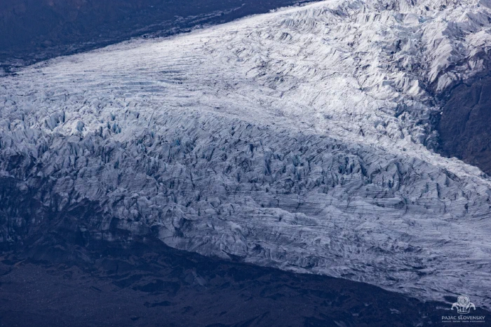 Crevasse field rippling across a glacier tongue at dusk