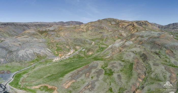 Geothermal valley, moss-green floor below ochre-streaked rhyolite slopes