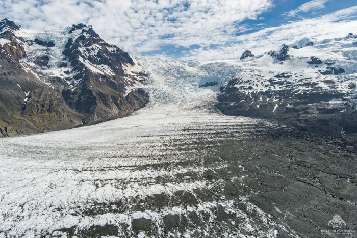 Aerial of ogive bands curving down a glacier icefall