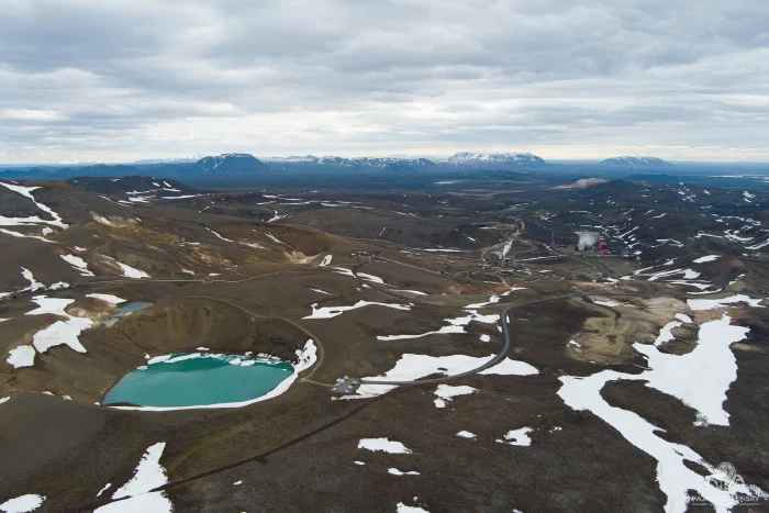 Krafla's Víti crater and steaming geothermal valley seen from the air