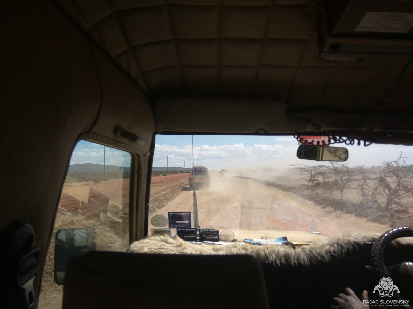 Red dust road to the Masai Mara seen through the Land Cruiser's windshield