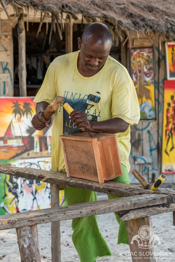 Portrait with the adze mid-stroke