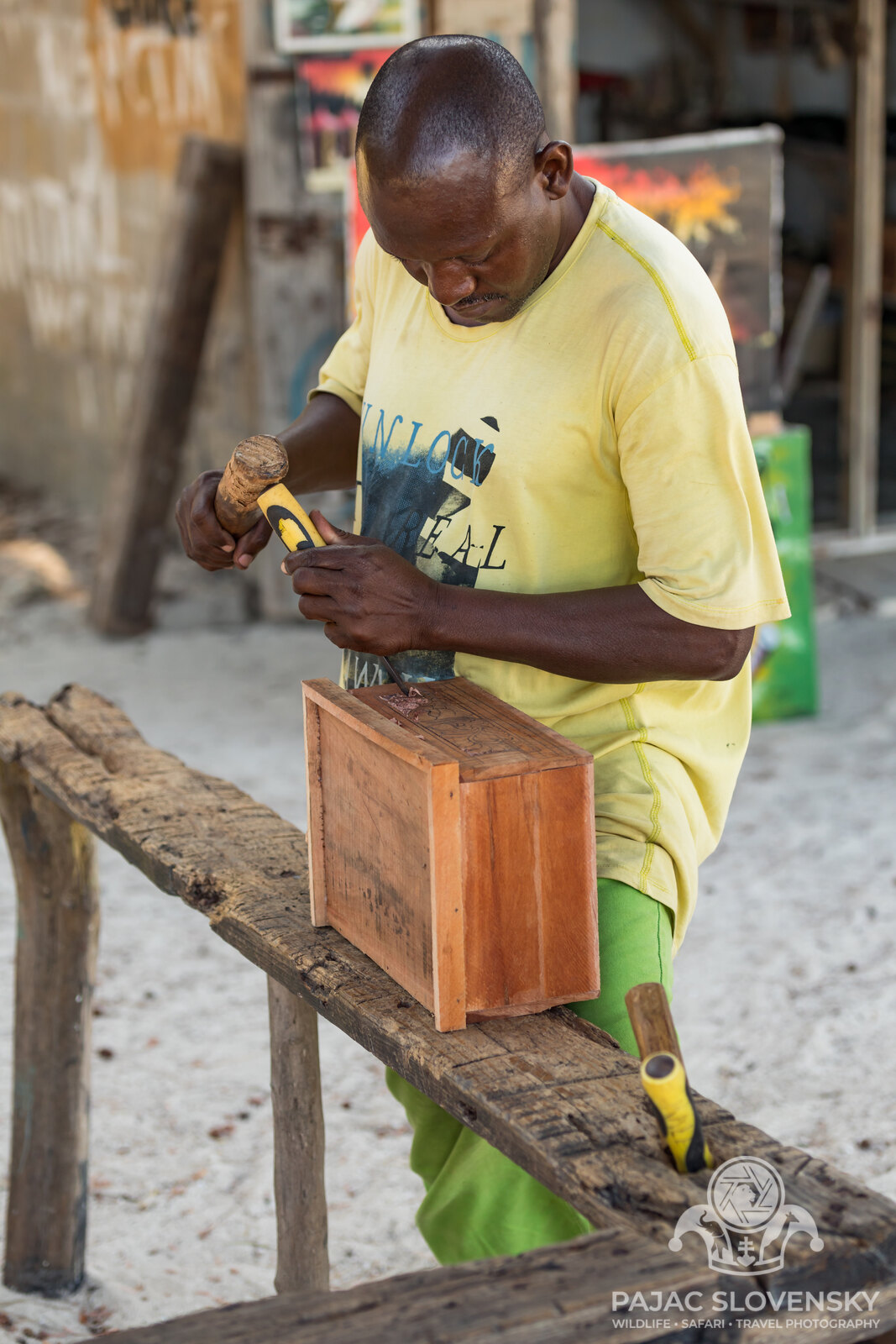 The carpenter in complete focus over a single carved line