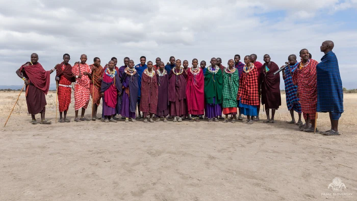 Group portrait of Maasai villagers in shuka robes and beaded collars