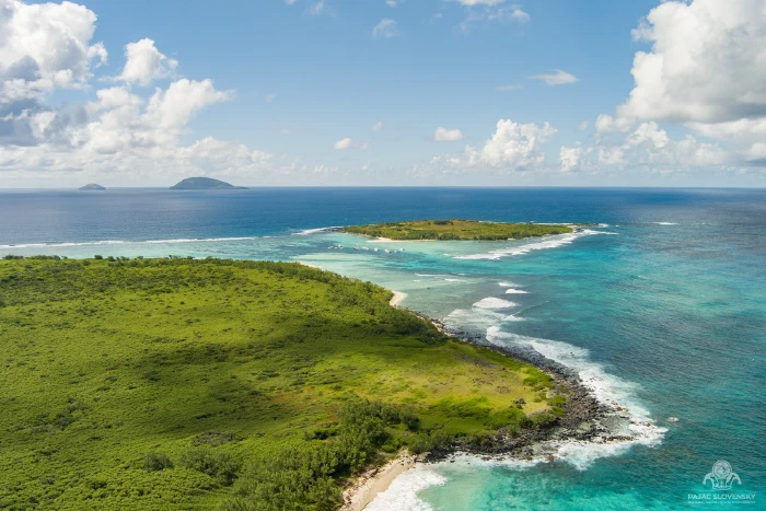 Aerial across Flat Island's interior toward Gabriel Island's reef channel