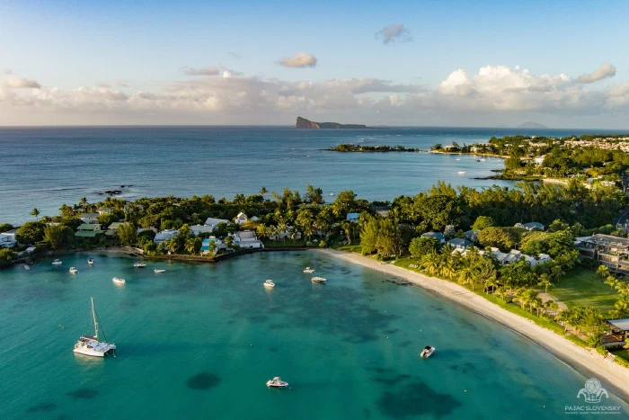 Aerial of Grand Baie's moored boats with Coin de Mire on the horizon