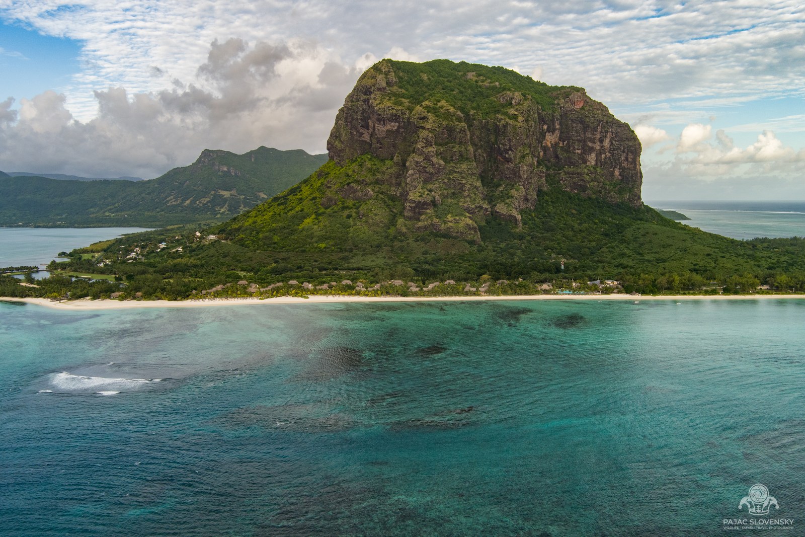 Le Morne Brabant rising over its turquoise lagoon, seen from the air