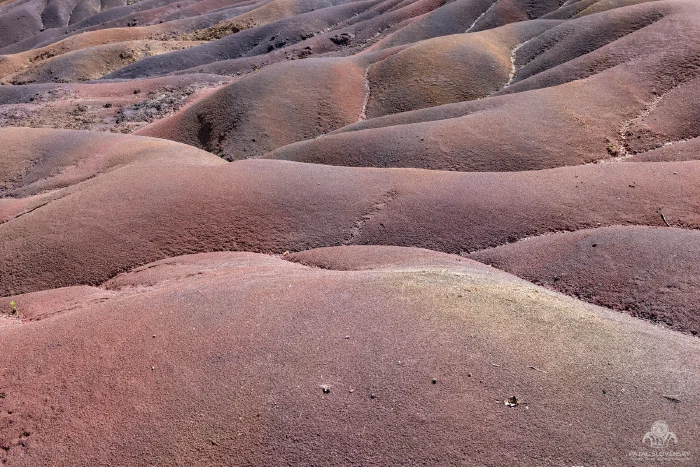 Close ridges of red and purple volcanic sand at the Seven Coloured Earths