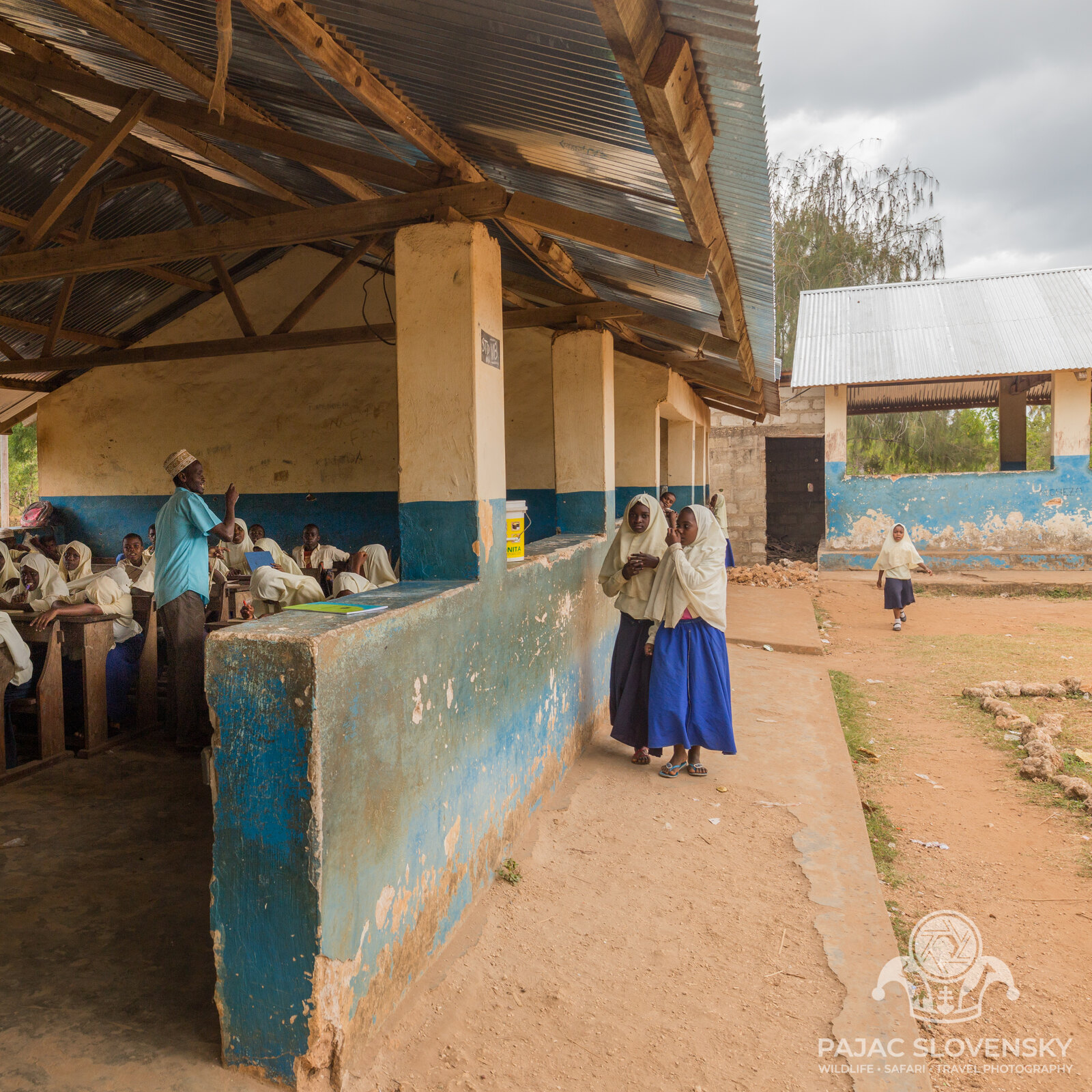 Pupils in blue and white filling the school veranda