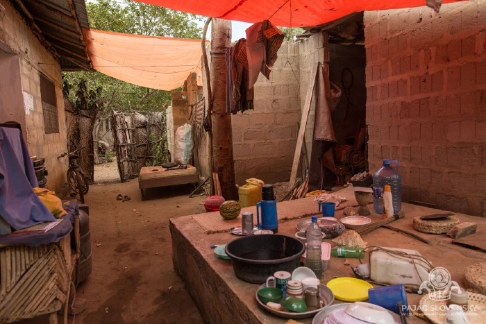 Inside a village shop — the day's goods under a tarpaulin roof