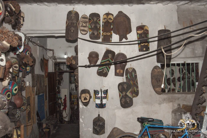 Masks and trinkets hung across a shop wall