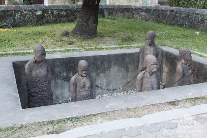 The slave-trade memorial: stone figures chained in a sunken pit, Stone Town